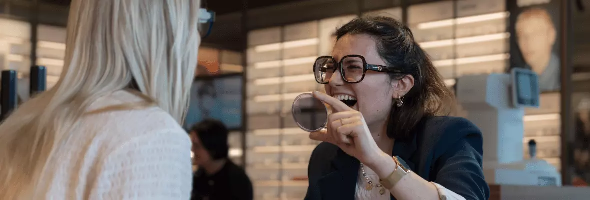 Nareen en Madelief transitions glazen Pearle jobs Zelfstandig zaakvoerder Nareen laat klant een  montuur passen en het effect van meekleurende  glazen zien terwijl ze samen lachen